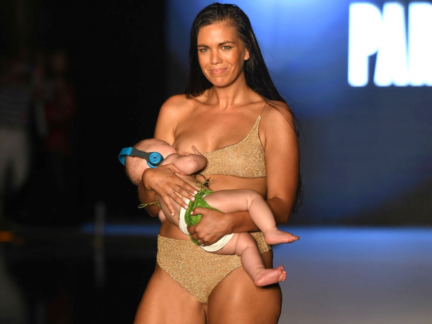 Une mannequin américaine allaite sa petite fille durant un défilé en maillot de bain